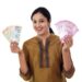 Young Indian woman holding currency notes agianst white background