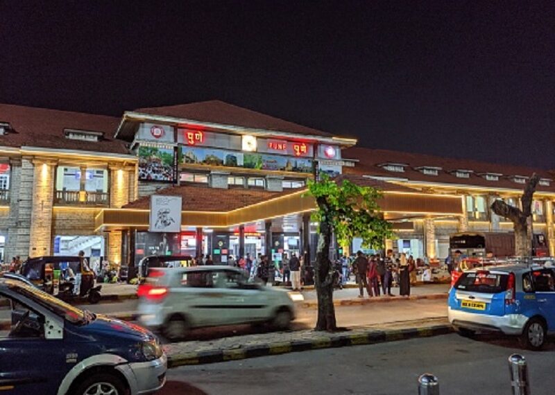 Pune, India: Vehicles are running and passengers are moving in lane outside Pune railway station at night. Pune is second biggest Information technology hub of India and second largest city of Maharashtra state in India.
