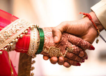 Beautiful Photo of handshake of a newly married Couple In India, promising each other love and affection for the rest of their life.