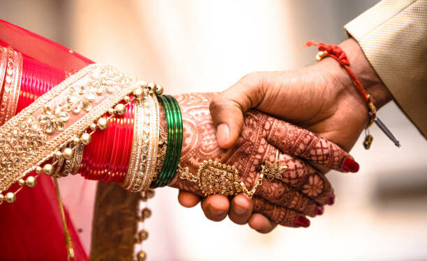 Beautiful Photo of handshake of a newly married Couple In India, promising each other love and affection for the rest of their life.