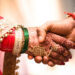 Beautiful Photo of handshake of a newly married Couple In India, promising each other love and affection for the rest of their life.